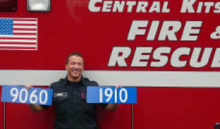 Central Kitsap Fire & Rescue firefighter/paramedic Kevin Bernt holds up address signs