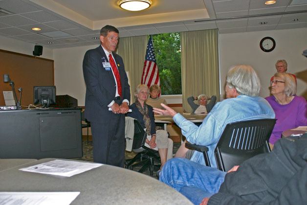 Harrison Medical Center CEO Scott Bosch listens to a question about the planned affiliation with Franciscan Health System during a public forum sponsored by the CK Community Council and the League of  Women Voters.