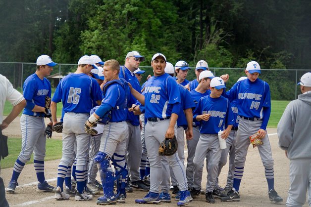 The Trojan team breaks from a huddle between innings during their West Central District game against Klahowya