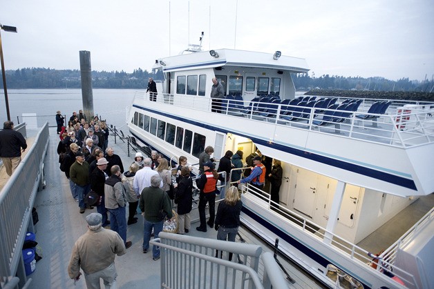 Passengers file onto the Spirit of Kingston in October 2010 for the first morning of SoundRunner service.