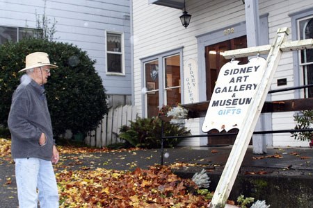 Sidney Museum & Arts Association board president Jud Turner inspects the Port Orchard historic structure.