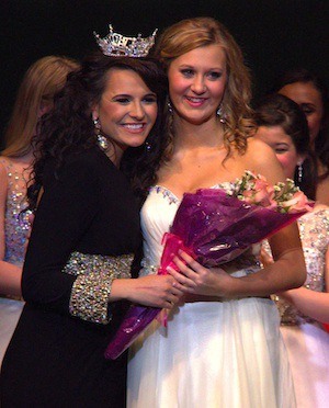 Emily Houston (right) receives a bouquet of roses from Miss Seattle 2013 Delia Lubanovici after she was named first runner-up at the Miss Miss Seattle Scholarship Pageant.