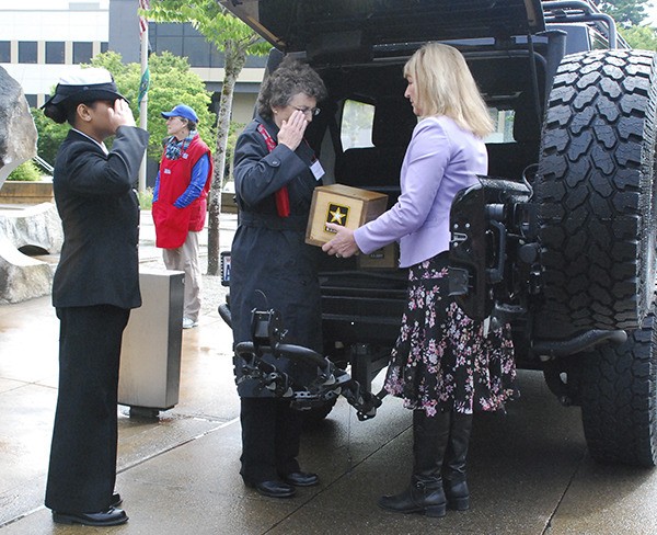 The remains of a service member was transferred to an official of The Unforgotten Ride to Tahoma Memorial Day Ceremony May 28 outside the Kitsap County Administration Building. Remains of other service members are traditionally carried on this day annually for rest at the Tahoma National Cemetery in Covington