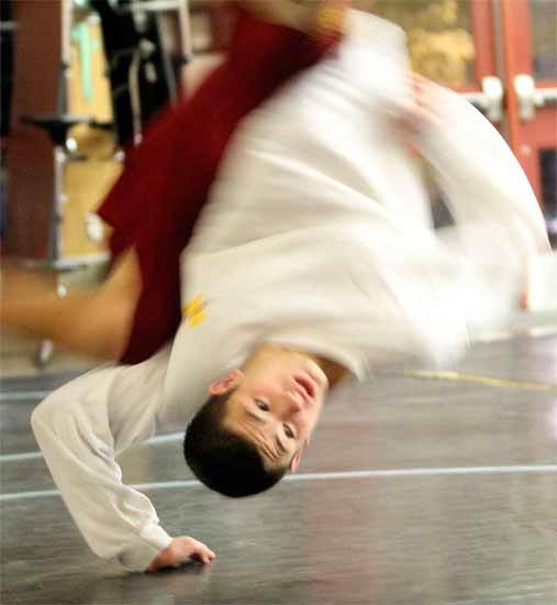 Kingston’s Bobby Reece III performs a Granby roll during practice Monday in the Kingston High School Commons. A Granby roll — a shoulder roll — is typically used when the top wrestler has a hold on the lower wrestler’s waist. Reece took the 140-pound Division 2A State title last season.