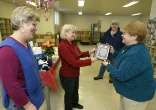 Keyport Postmaster Sally Knowlen (center) presents Robyn Hartz (right) with a plaque for her 21 years of service with the United States Postal Service Tuesday