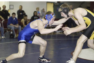 Defending Class 3A 130-pound champion Branden Yeik (left)