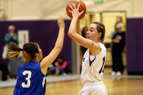 North Kitsap's Molly Lemmon looks for an open player to pass to during the Olympic League varsity basketball game Jan. 8 in the North Kitsap High School Gymnasium. Lemmon led North Kitsap with 18 points.