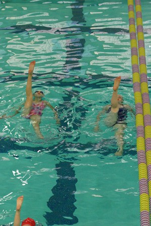 Swimmers from the Kitsap Water Blossoms train in the Kitsap Community Pool on Tuesday