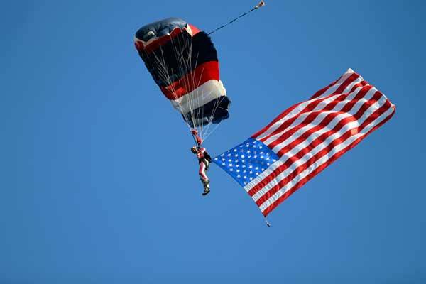 Andy Farrington and three fellow skydivers delivered the baseball to the Babe Ruth World Series opening ceremony for the traditional first pitch.