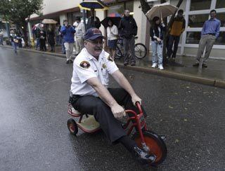 Bremerton Fire Department Chief Al Duke rides a tricycle in the second annual Bremerton Trike Race to help raise funds for United Way of Kitsap County Oct. 3.