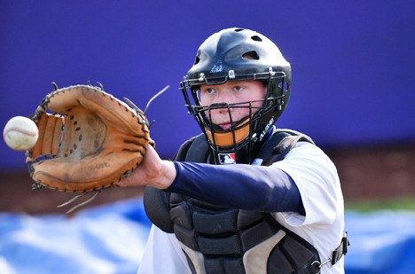 North Kitsap High catcher Nick Benish warms up Monday at the school’s baseball field in Poulsbo. The North Kitsap and Kingston High teams are hoping to return to the state tournament this season.