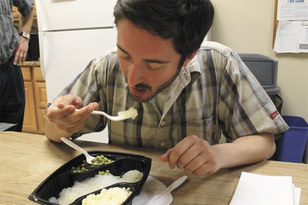 Herald reporter Kipp Robertson takes another bite of lutefisk during a taste test