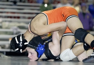 Bremerton's 103-pound Lauren Richardson (bottom) fights out of a hold against A.C. Davis during the opening round of Saturday's Olympic Duals at the Kitsap Fairgrounds Pavilion.