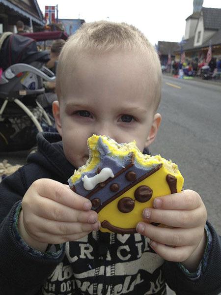 2-year-old Ryder Stone with an appropriately-themed cookie from Sluys Bakery during the Viking Fest parade