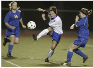 Trojan Ali Brown strikes a shot Tuesday against Bremerton. Brown scored the winning goal in the 77th minute to give Oly a 1-0 win.