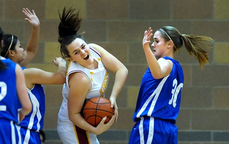 Kingston High School's Elsa Brown fights for a rebound against Olympic High's Jessica Klump