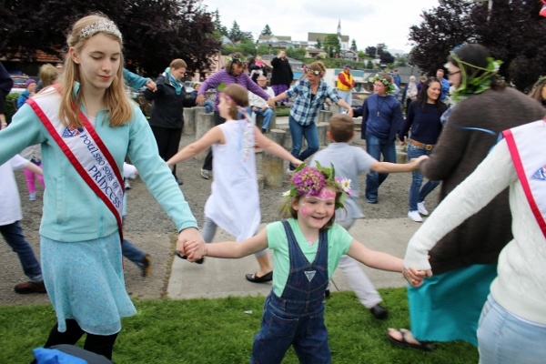 Celebrants dance to a traditional song after the raising of the maistang at Midsommarfest