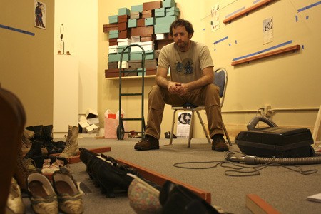 Kitsap Historical Museum Curator Scott Bartlett takes a break Tuesday while setting up the museum’s latest exhibit