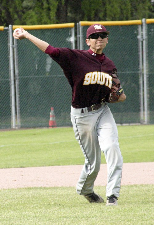 South Kitsap third baseman Zach Mendiola guns down a runner at first during the Wolves' to Olympia on Saturday in Kent.