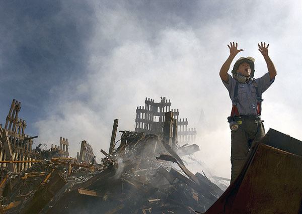 A New York City fireman calls for 10 more rescue workers at the rubble of the World Trade Center