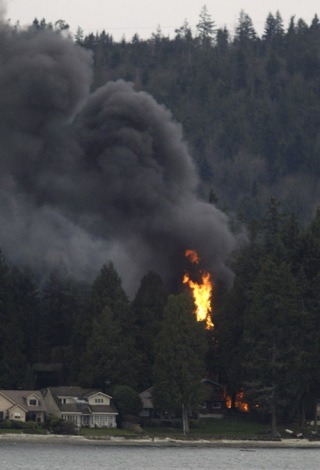 Local firefighters battled a garage fire Saturday afternoon on Erlands Point Road in Bremerton. Multiple people from Silverdale and Bremerton called 911 to report the blaze.