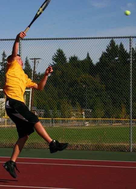 North Kitsap's Chris Gracey returns a shot from Kingston's Erik Reichert Monday at the Kingston High School tennis courts. Gracey and doubles partner Nick Tedford won 6-1
