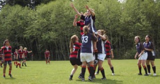 (Top) Members of the Kitsap Grenades U19 girls rugby team hoist a player in the air with possession in limbo. (Left) Kayla Calhoon-Renzo runs with the ball. (Right) Amber Payne tackles an opponent.