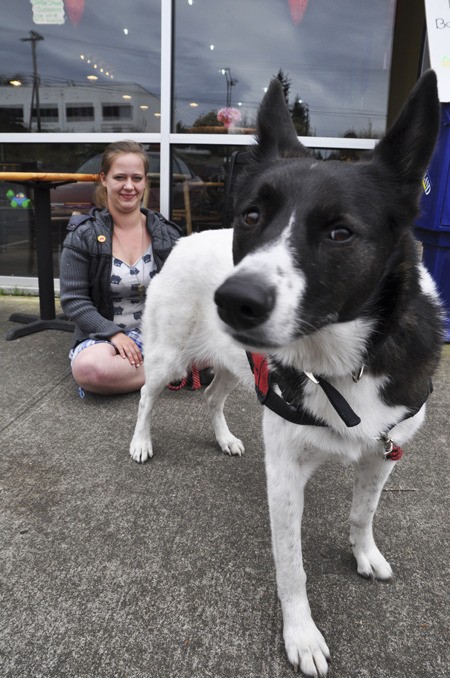 Kayla Rochelle sits with her therapy dog Stella outside her work at Steel City Café in Bremerton.