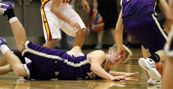 Sequim's Frank Catelli lands hard on the court after colliding with a player from Kingston High School Tuesday night. It was a hard-fought game that Kingston won to keep its undefeated Olympic League record.