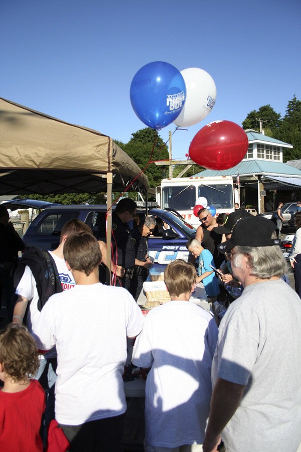 Port Orchard police officers visit with people and offer information on crime prevention