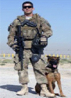 Navy Petty Officer 2nd Class Sean Brazas with his military working dog