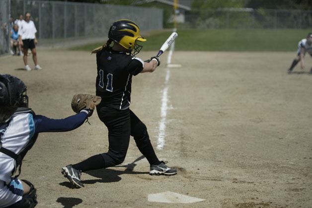 An Olympic High School player takes a swing at a pitch in a past season.