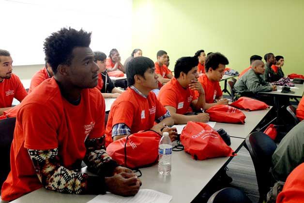 Students listen to Sam Morgan lead a workshop discussing the challenges students may face transitioning into college life at the Men of Color Summit May 20 at Olympic College.