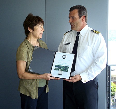 Capt. Jonathan Thomas of the schooner Fiddler's Dream presents music teacher Jane Landstra with a commission to write a song for the schooner.