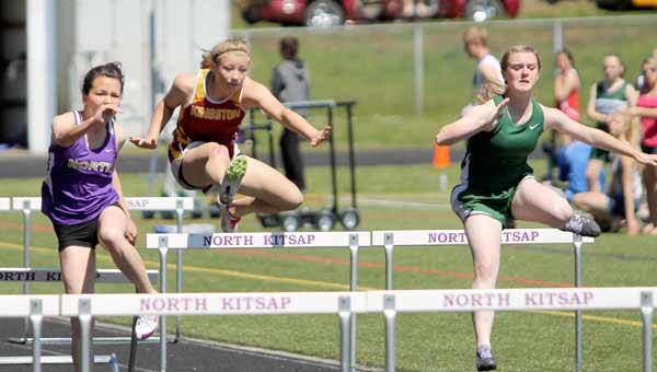 Kingston's Peyton Reece sails over a hurdle during the first heat of the 100m Hurdles May 4 during the Olympic League track and field championships.