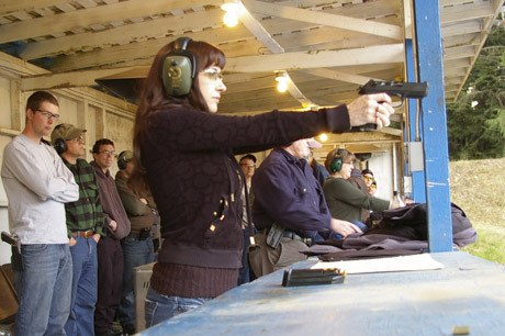 Aim. Breathe. Hold. Squeeze. The Kitsap Rifle and Revolver Club holds weekly and annual shooting competitions in Seabeck. These shooters are taking part in a falling plates competition.