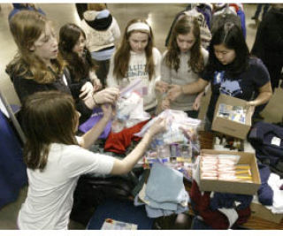 Students from Hyla Middle School on Bainbridge Island (left) were on hand Friday handing out clothes and hygiene items to those in need during last week’s Operation: Connect at the Kitsap Fairgrounds.