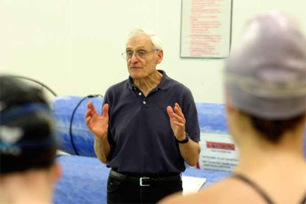 Dick Hannula coached the North Kitsap and Kingston High School girls swim teams on Tuesday at the North Kitsap Community Pool. Hannula