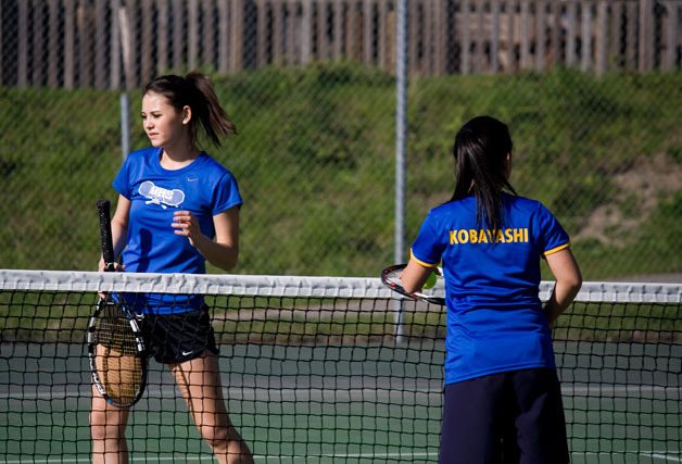 Annemarie Herbert and Kyoko Kobayashi meet at the net to switch sides on Monday.