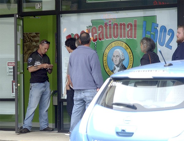 Security personnel checks a driver license of an individual before entering the Crockpot