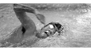 Above: North Kitsap swimmer Jordan Johnson competes in  the 100-freestyle during home action against Port Angeles on Tuesday.  Below: Viking Troyce Musick is having a “fantastic season