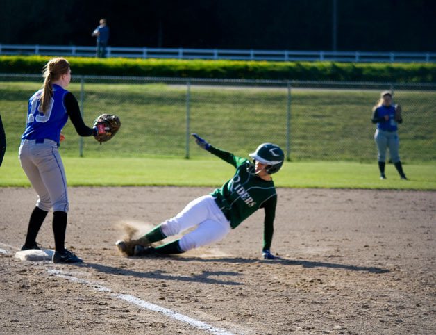 Trojan third-baseman Kendra Warner awaits the throw to third during Monday’s game against Port Angeles.