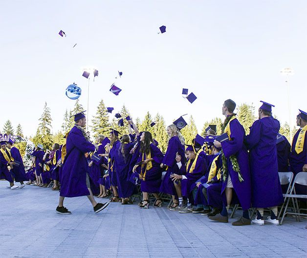 North Kitsap High School graduates celebrate at the end of the graduation ceremony June 12 by tossing their caps in the air.