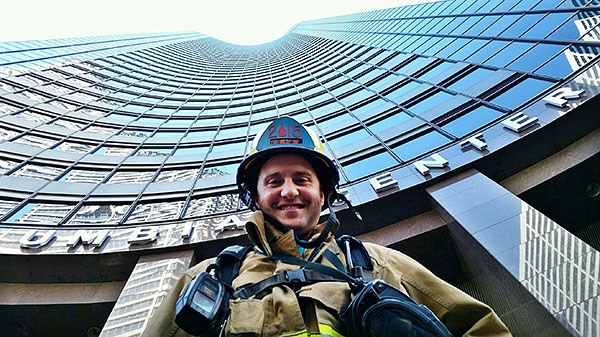 Central Kitsap Fire and Rescue firefighter Brian Fuchs stands in his turnout gear in front of the Columbia Center skyscraper in downtown Seattle during the 24th annual Scott Firefighter Stairclimb on March 8.