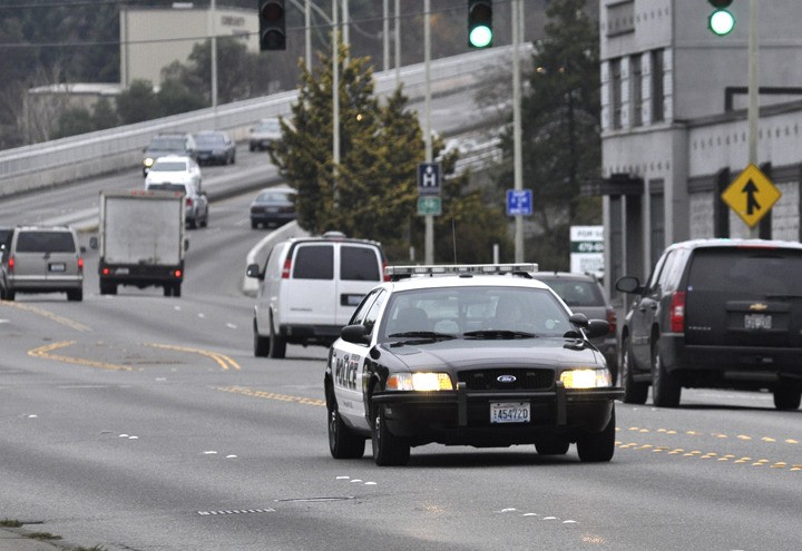 A Bremerton police cruiser rolls down Warren Avenue Tuesday afternoon. Bremerton police use twice the fuel per car as Seattle police.