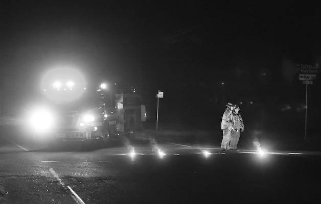 Firefighters direct traffic on Suquamish Way Saturday evening after a boat and trailer collided with a Jeep SUV.