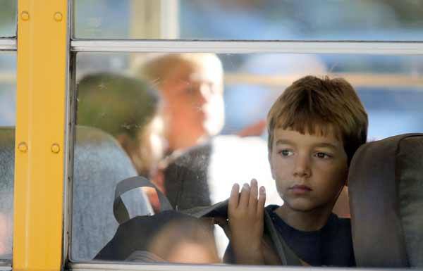 Students prepare to unload from the bus for the first time of the 2012-13 school year at Poulsbo Elementary Sept. 5.