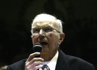 (Top) Les Eathorne speaks to the sold-out crowd during halftime of Monday’s alumni basketball game between East and West High at the newly named Les Eathorne Gymnasium and Ken Wills Court at Bremerton High School. (Left) East alum Rick Walker scored 20 points to lead the Knights to a 69-45 victory. He was named Most Valuable Player. (Right) The game included players who graduated from as far back as 1958. Eathorne