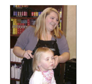 Stylist Barbie Swainson touches up her daughter Jasmine’s hair in anticipation of Sunday’s spa event at the Brass Ring in Port Orchard