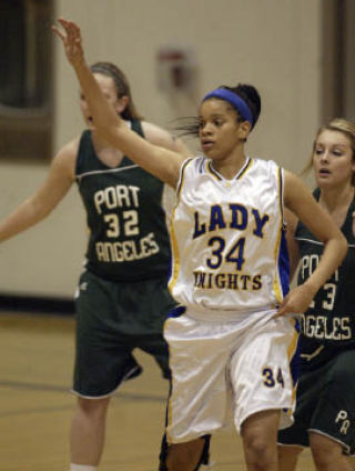 (Above) Bremerton’s Jalen Carpenter fights for position against two Port Angeles defenders during the Lady Knights’ 72-41 loss Tuesday.  (Right) Carpenter